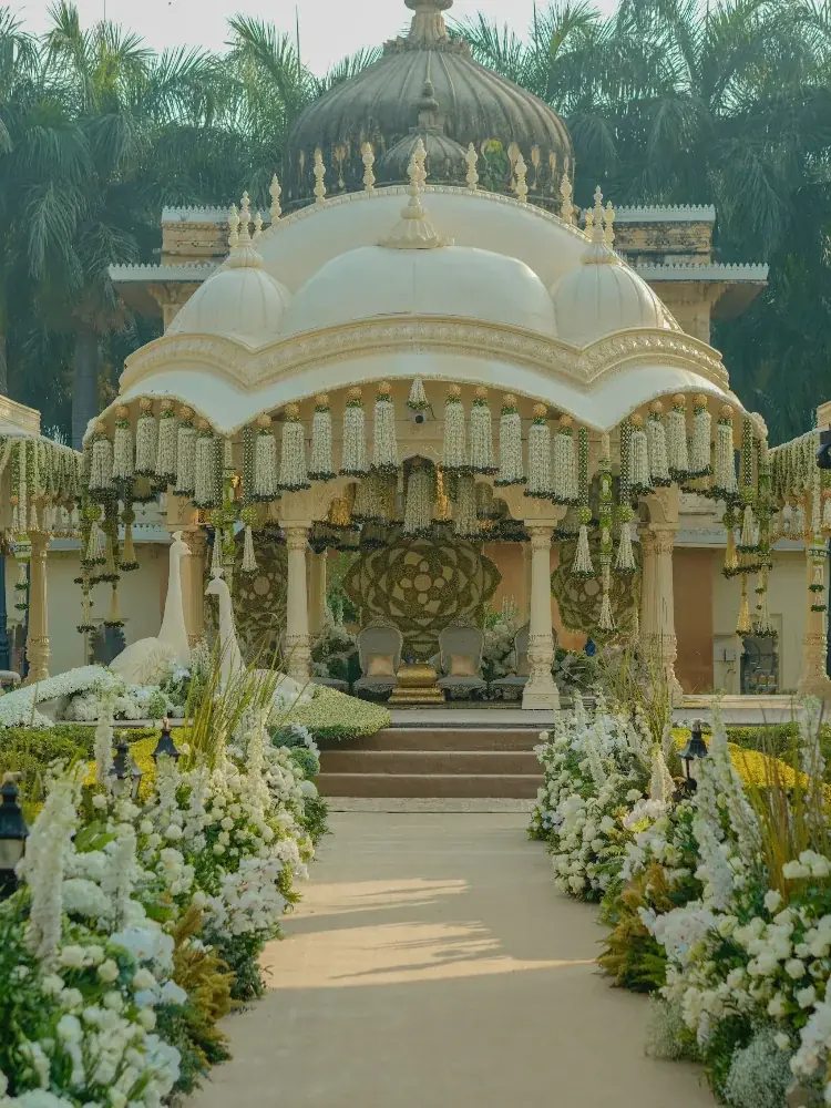 An ornate mandap draped in jasmine and white flowers